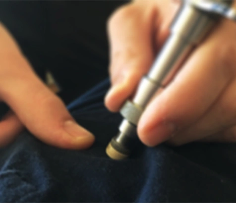 Close-up of a handheld chiropractic adjustment instrument