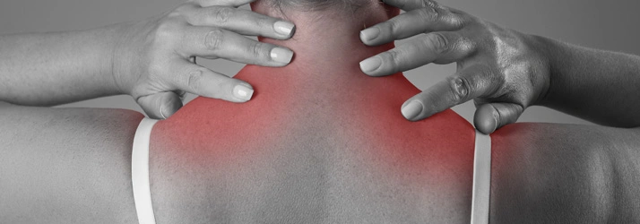 Close-up of a person pressing both hands onto the upper back