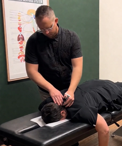 Person administering a chiropractic neck adjustment